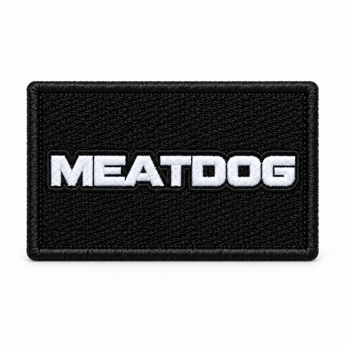 Black rectangular MEATDOG embroidered patch with a white wordmark and black stitched border